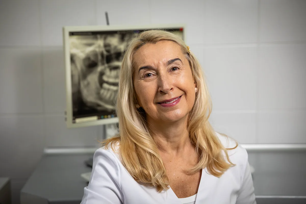 Lekarz stomatolog w gabinecie na tle zdjęcia pantomogramu uzębienia